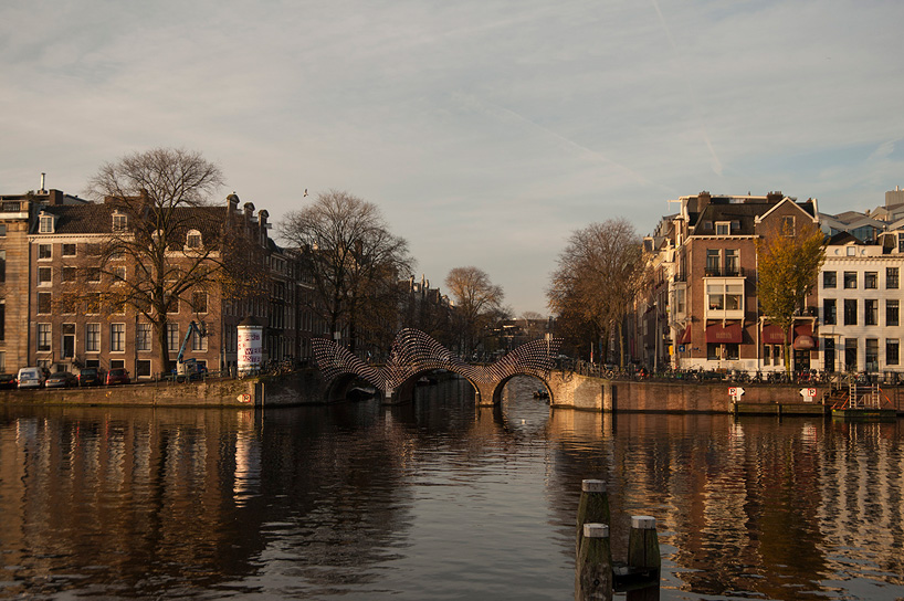 tjep. illuminates amsterdam's canals with undulating light bridge