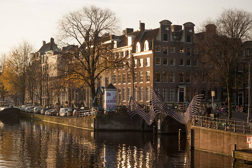 tjep. illuminates amsterdam's canals with undulating light bridge