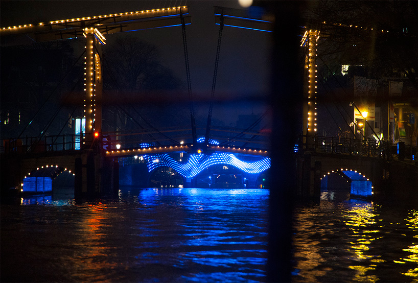 tjep. illuminates amsterdam's canals with undulating light bridge