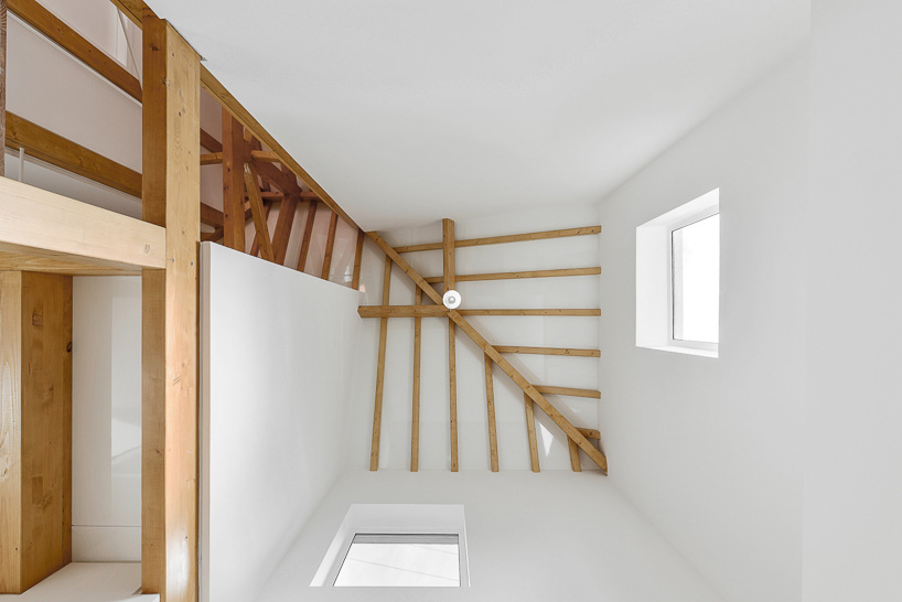 corpo atelier wood structure inside stone walls portugal designboom