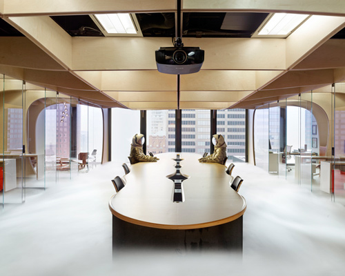 partisans delineates office space with a waffle of plywood surfaces 