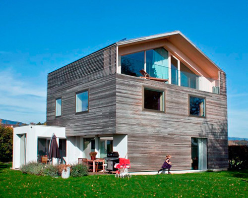 atelier azar renovates and enlarges home with wooden paneled volume
