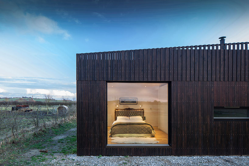 IPT architects clads howe farm residence in charred timber 