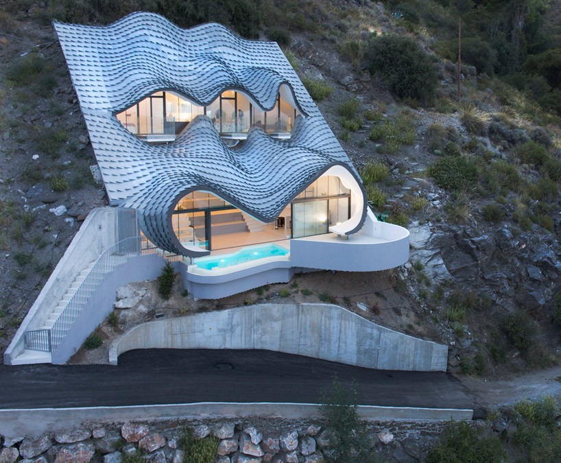 gilbartolomé buries metallic scaled residence into a cliff overlooking mediterrean