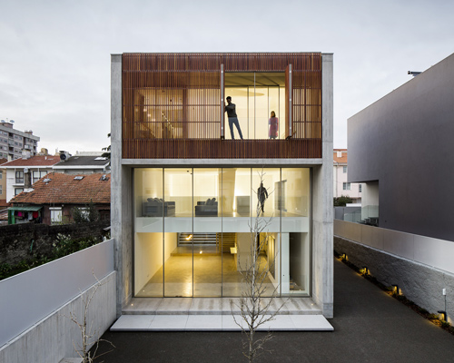 AZO reconstructs house in bonfim with concrete façades and adjustable timber screens