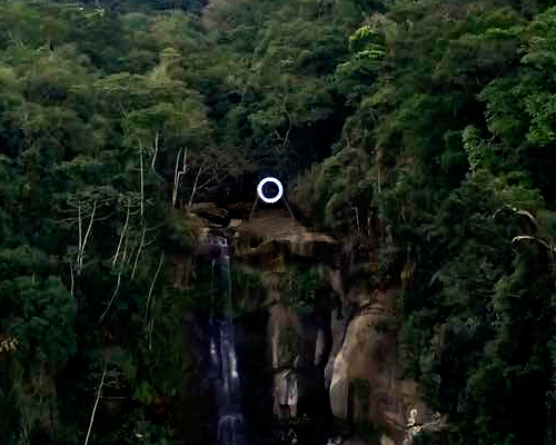 mariko mori sites luminous ring at the peak of a cascading waterfall in brazil