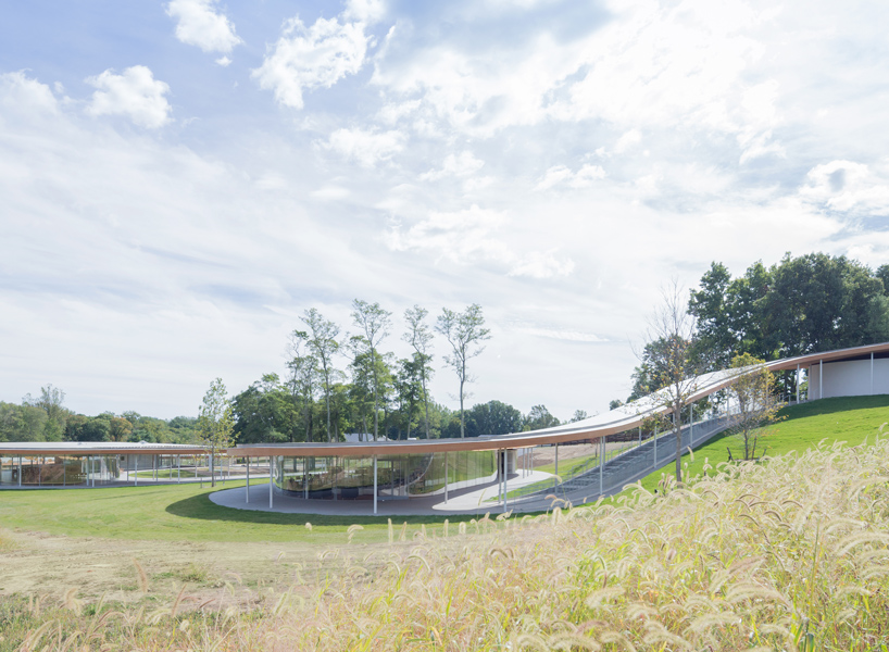 the building, which opened in october 2015, extends beneath a long roof ...