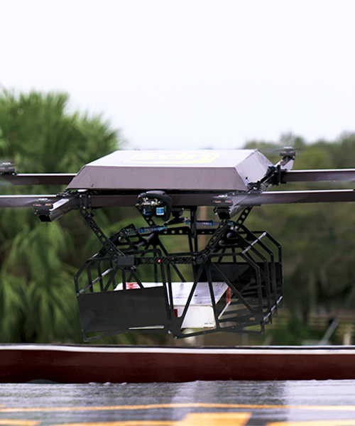 UPS delivery drone takes off from atop package car