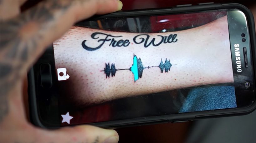 A person using a smartphone to view an augmented reality tattoo, with digital animations and interactive elements overlaid on the tattoo design.