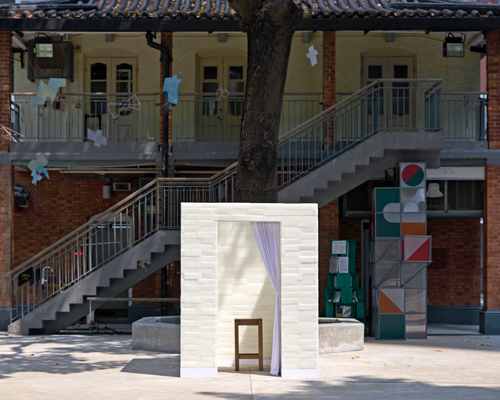 daydreamers design  installs confessional booth made of wax bricks in hong kong