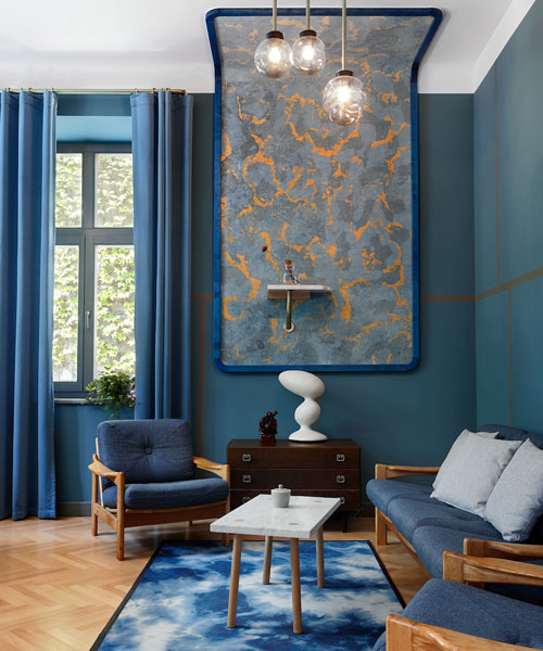 beza interiors revamps hand made's office using trademark gold and blue colors
