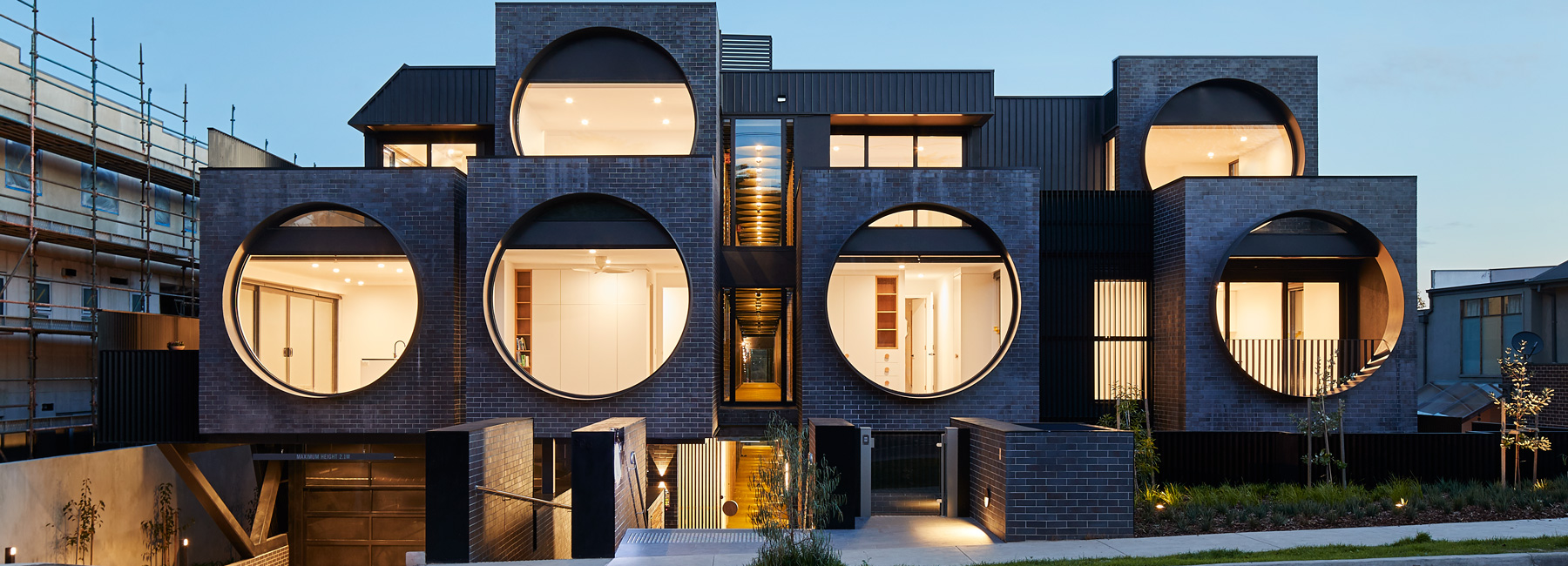 bkk architects frames cirqua apartments with oversized, circular windows