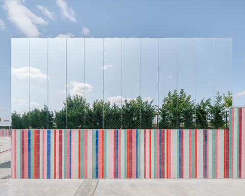 ABLM combines reflective mirrors with strips of vibrant colorful ceramic in school façade