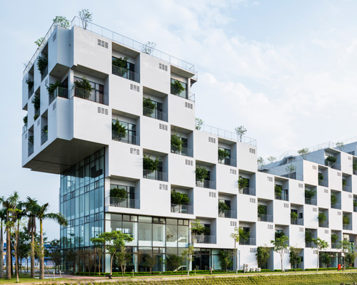 checkerboard façade of VTN's hanoi university building contains trees within recessed voids