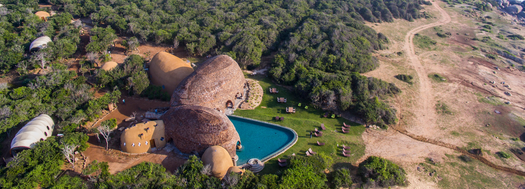 nomadic resorts + bo reudler studio open eco-resort out of massive rounded boulders in sri lanka