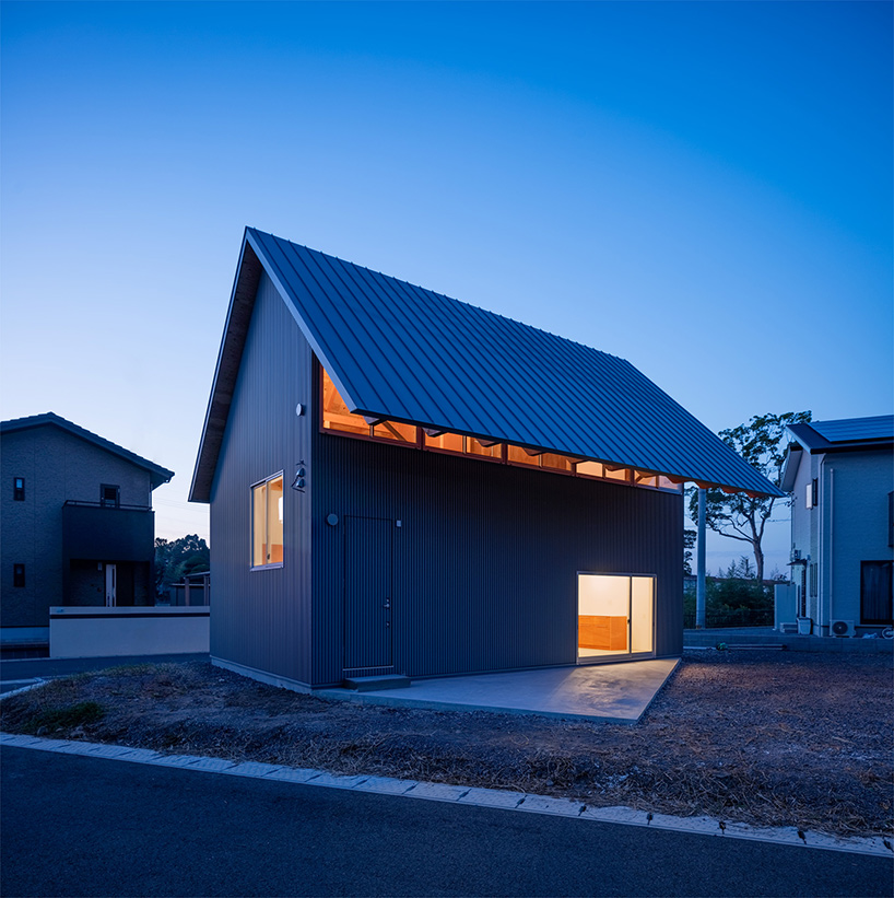 house in bungotakada by YAA is topped with a giant gable roof