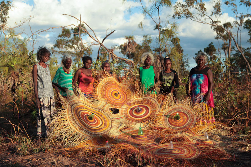 group of weavers from northern australia with finished PET plastic chandelier 
