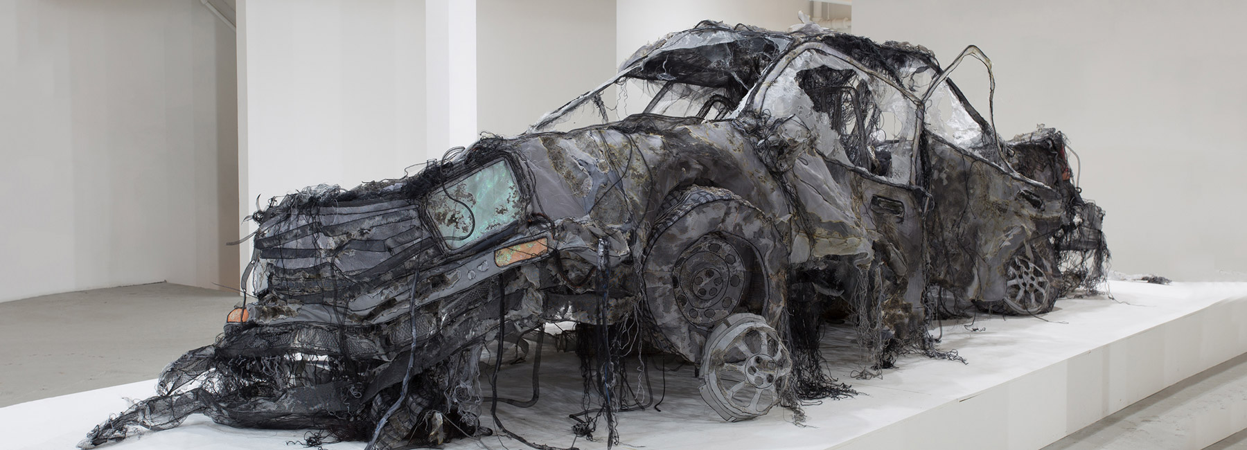 this full-scale demolished car is constructed from ghost-like textiles by jannick deslauriers