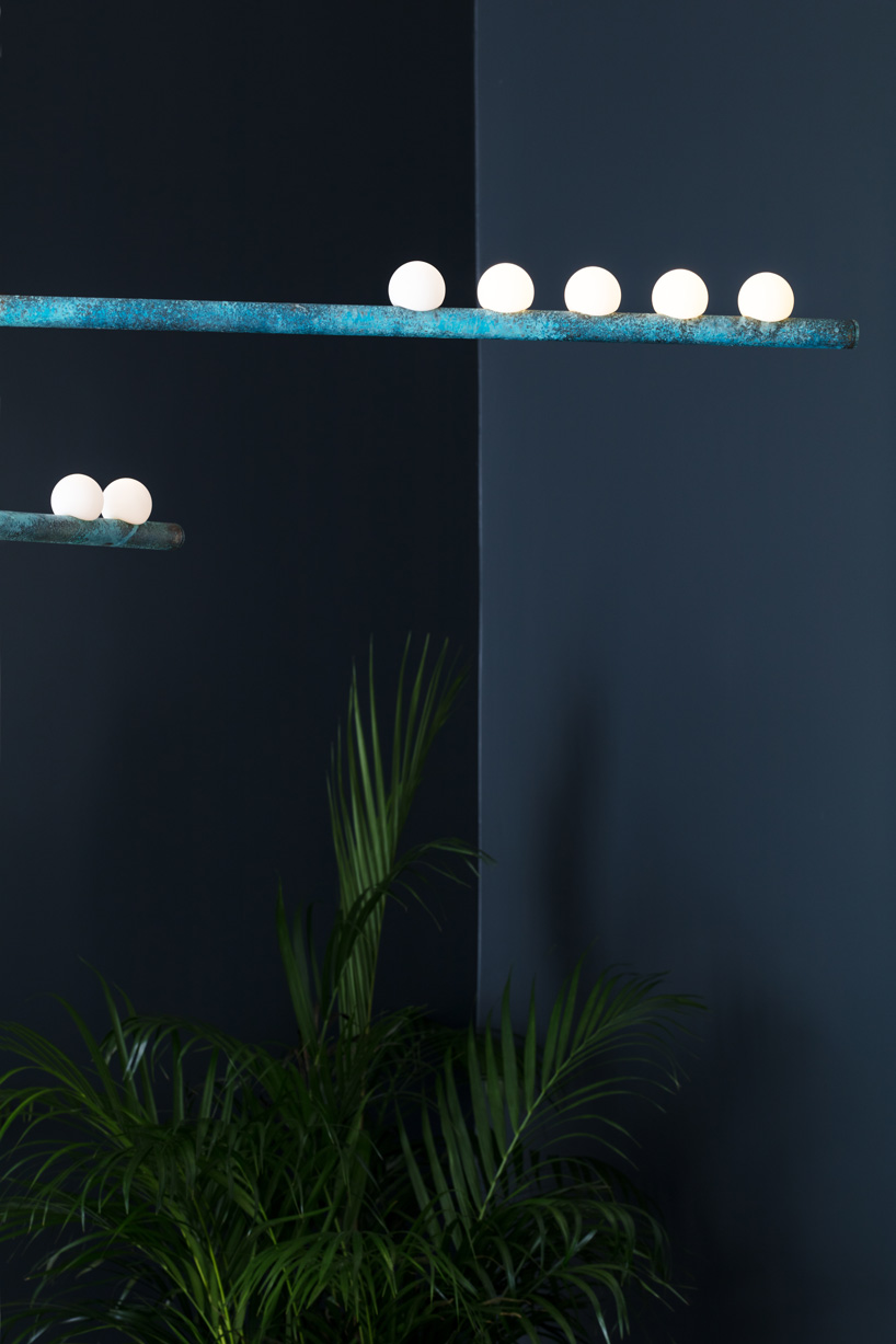 lindsey adelman's drop lighting system balances hand-blown globes on brass tubes