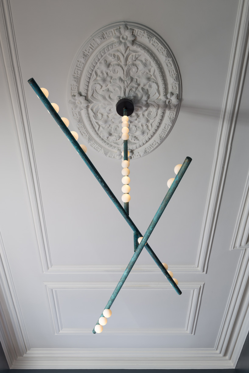 lindsey adelman's drop lighting system balances hand-blown globes on brass tubes