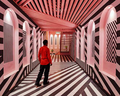 this restaurant in india combines pink interiors with bold zebra stripes