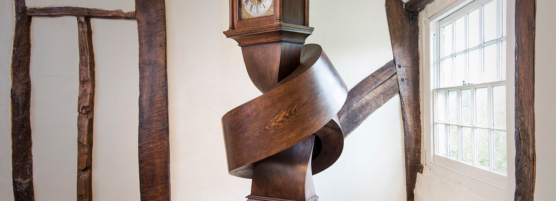 alex chinneck ties antique grandfather clock in a knot of ticks and tocks