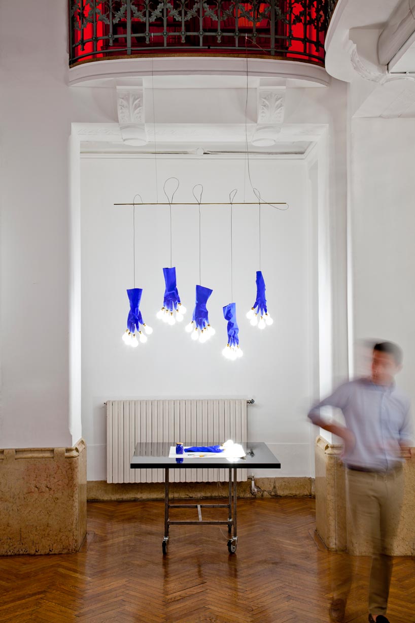 ingo maurer's luzy lights illuminate the fingertips of plastic gloves