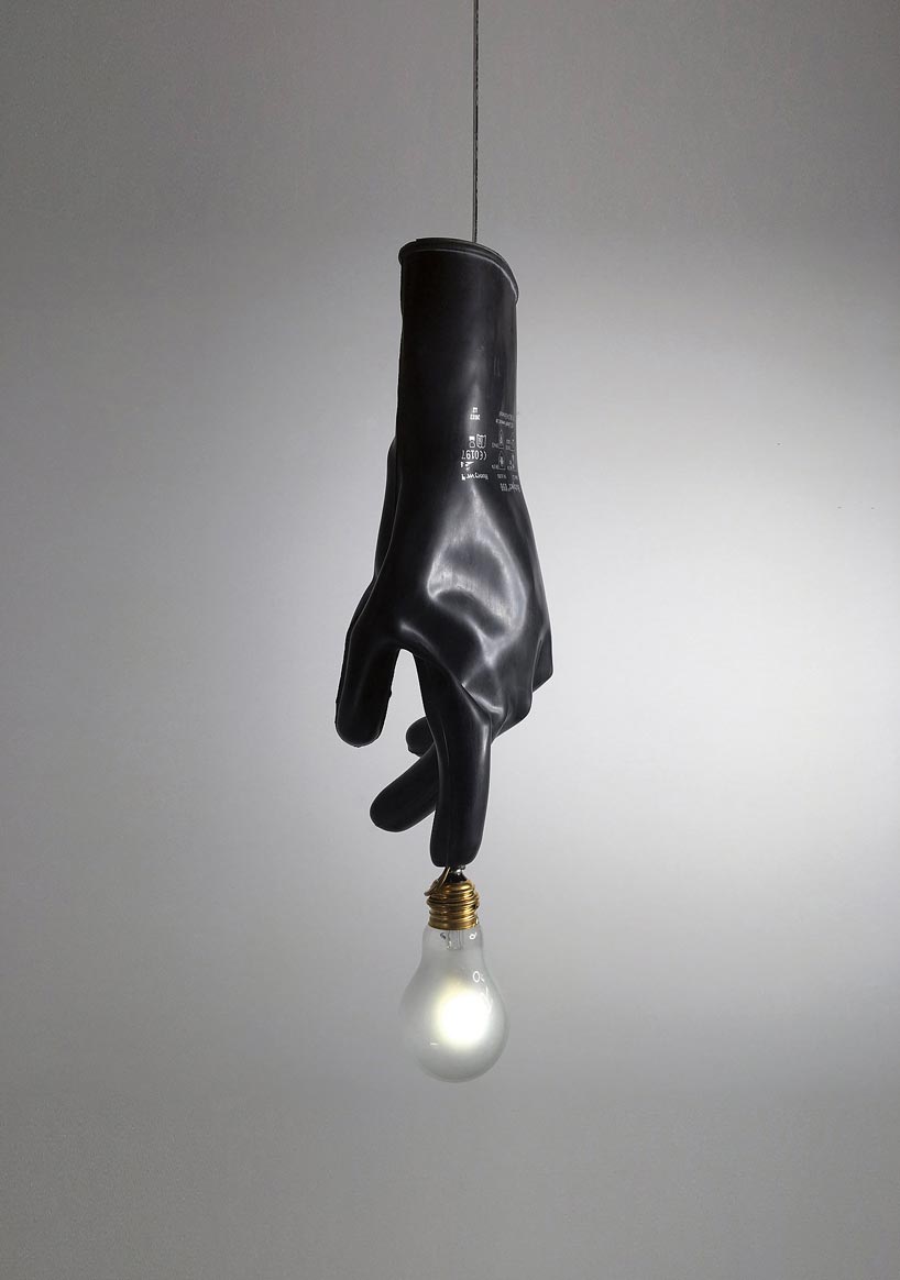 ingo maurer's luzy lights illuminate the fingertips of plastic gloves