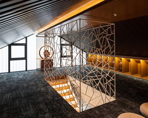cracked ice-patterned fence by minax encases one buddha's room's staircase