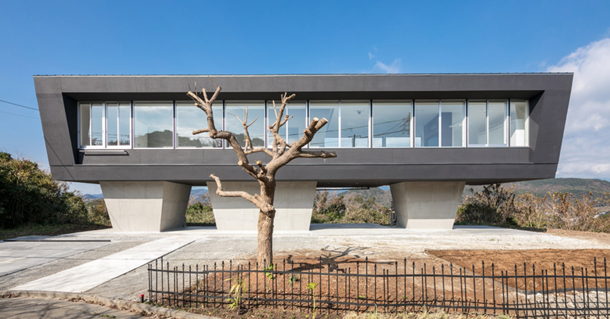 hiraoka architects sets a house on concrete legs on a hilltop in