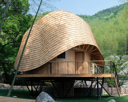 the undulating roof of this bamboo treehouse by monoarchi dictates its circular sequence of spaces