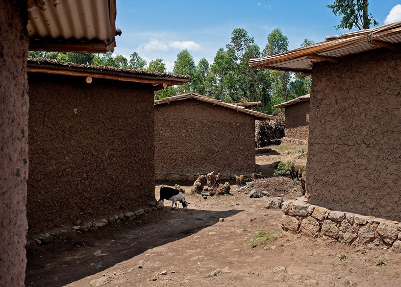 studio FH uses eucalyptus poles and rubble stone to build the batwa settlement in uganda