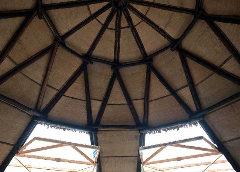 studio FH uses eucalyptus poles and rubble stone to build the batwa settlement in uganda
