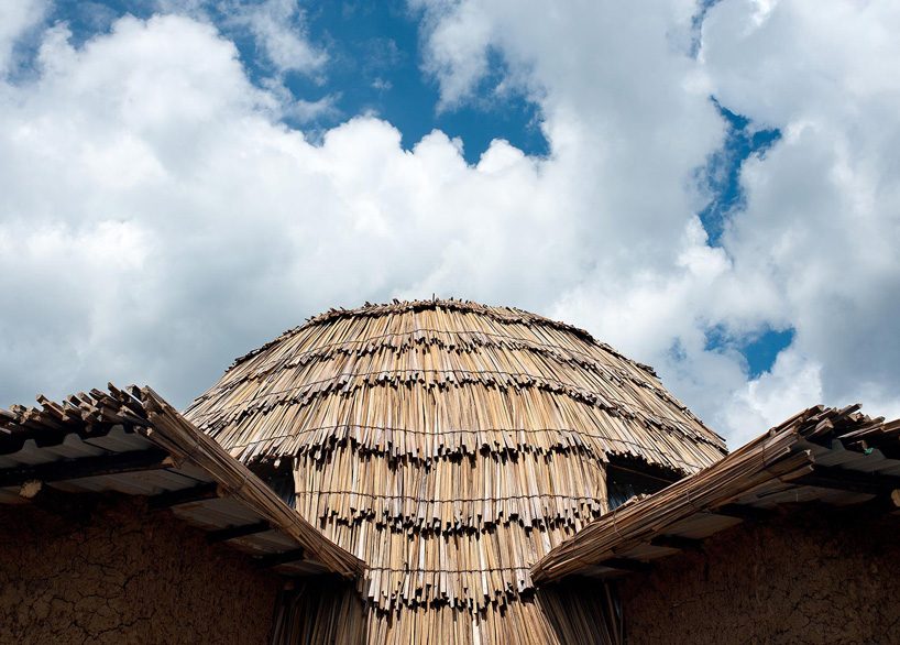 studio FH uses eucalyptus poles and rubble stone to build the batwa settlement in uganda
