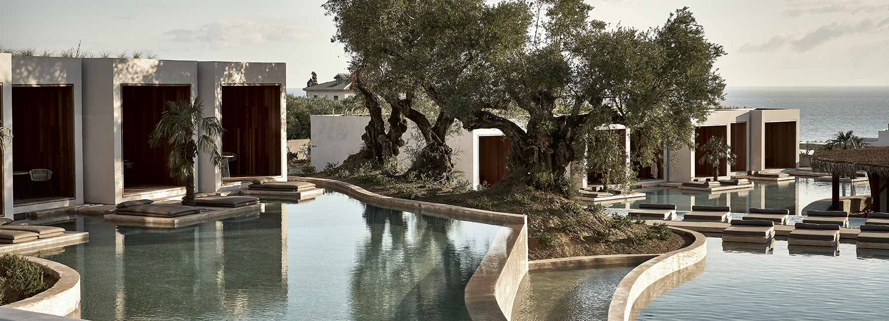 a hotel in greece by block722 surrounds a serene, man-made lake