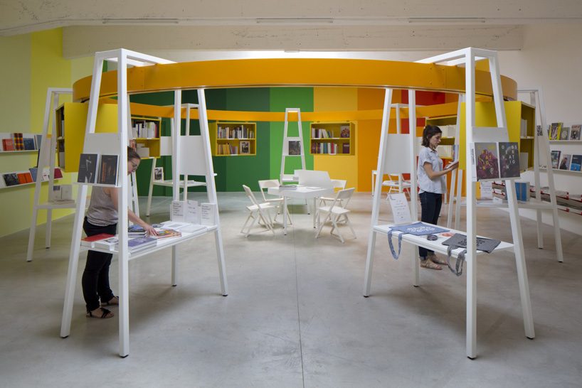 matali crasset suspends books in a circular monorail  for le consortium's bookstore in dijon designboom