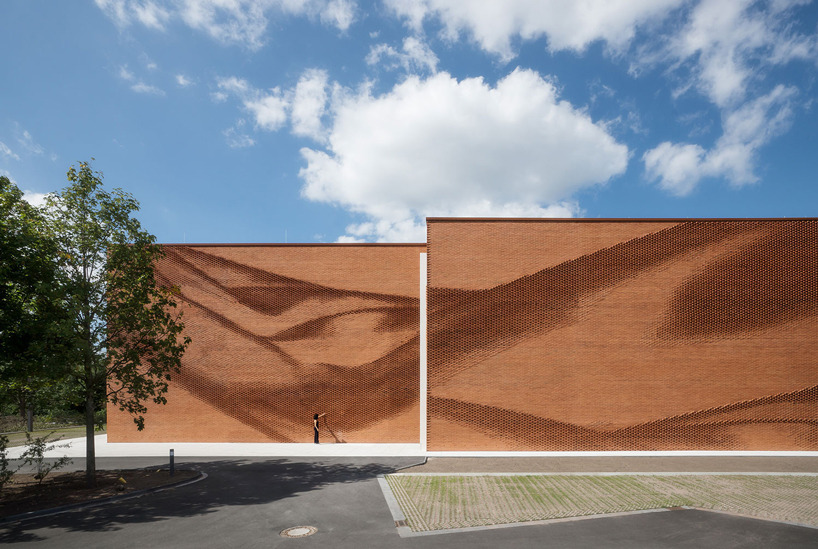 this undulating brick façade imitates the movement of draped fabric