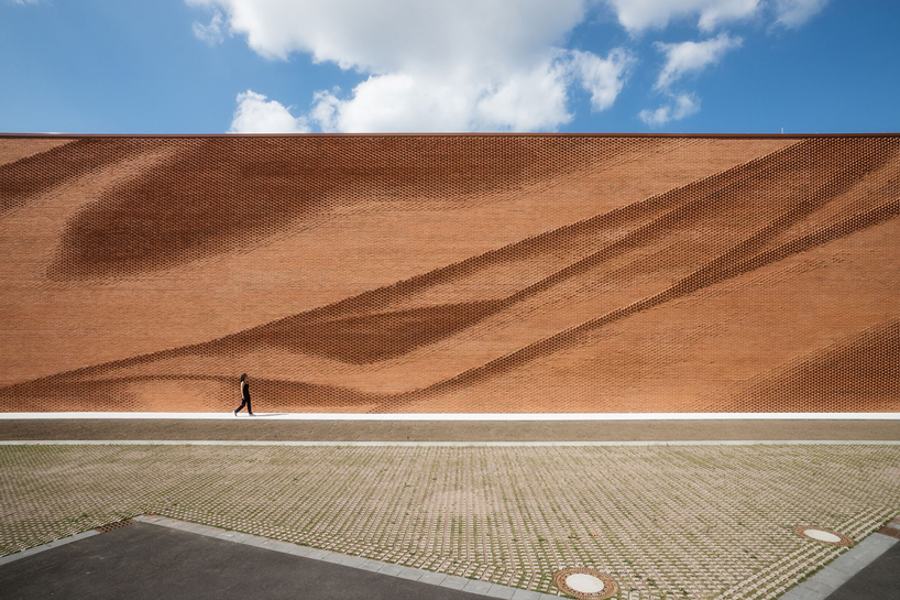 this undulating brick façade imitates the movement of draped fabric