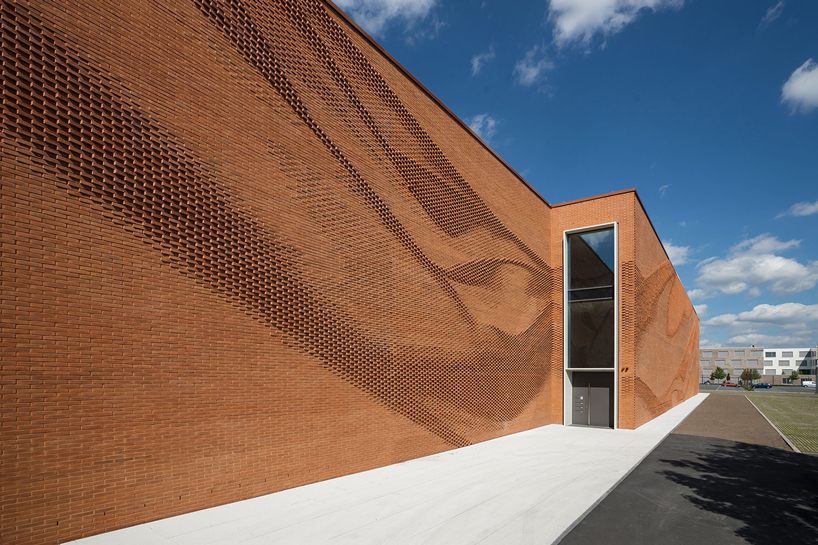 this undulating brick façade imitates the movement of draped fabric