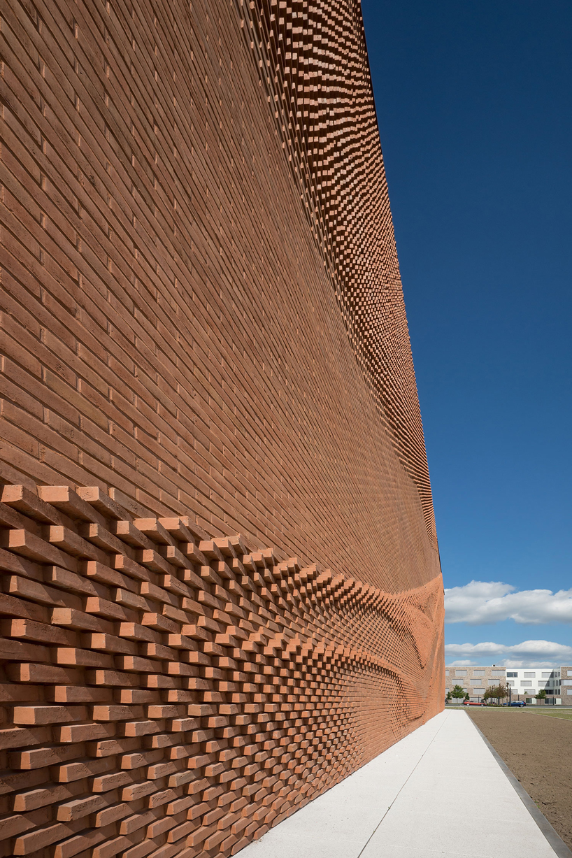 this undulating brick façade imitates the movement of draped fabric