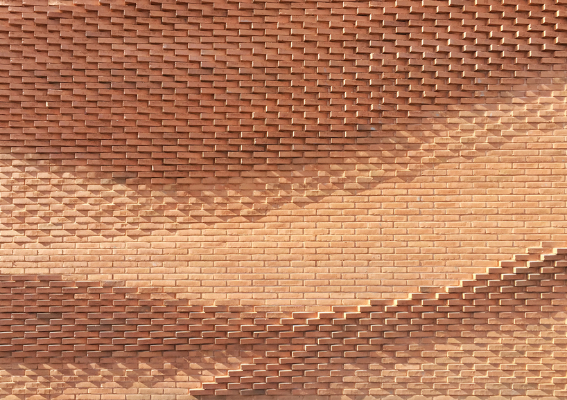 this undulating brick façade imitates the movement of draped fabric