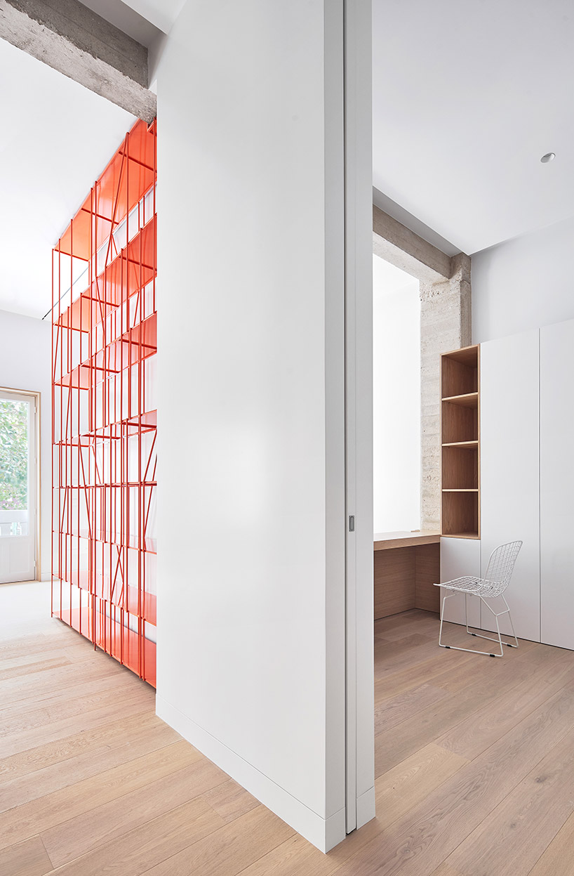 lucas y hernández-gil completes a madrid apartment with a coral-painted metal shelf designboom
