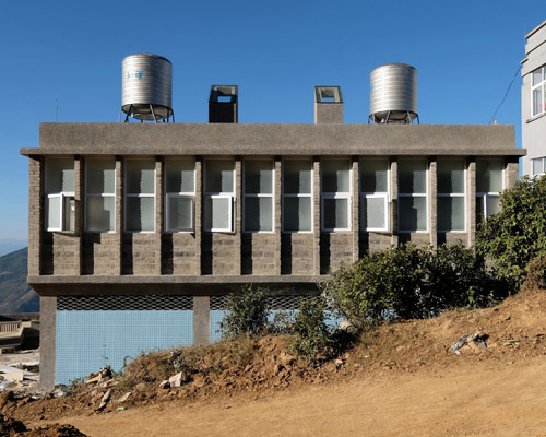 this grey brick building in rural china encourages children's hygiene habits