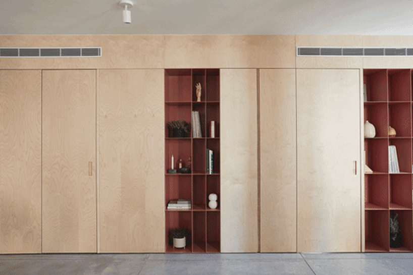 this apartment in tel aviv uses a wooden storage unit to separate private spaces - 1