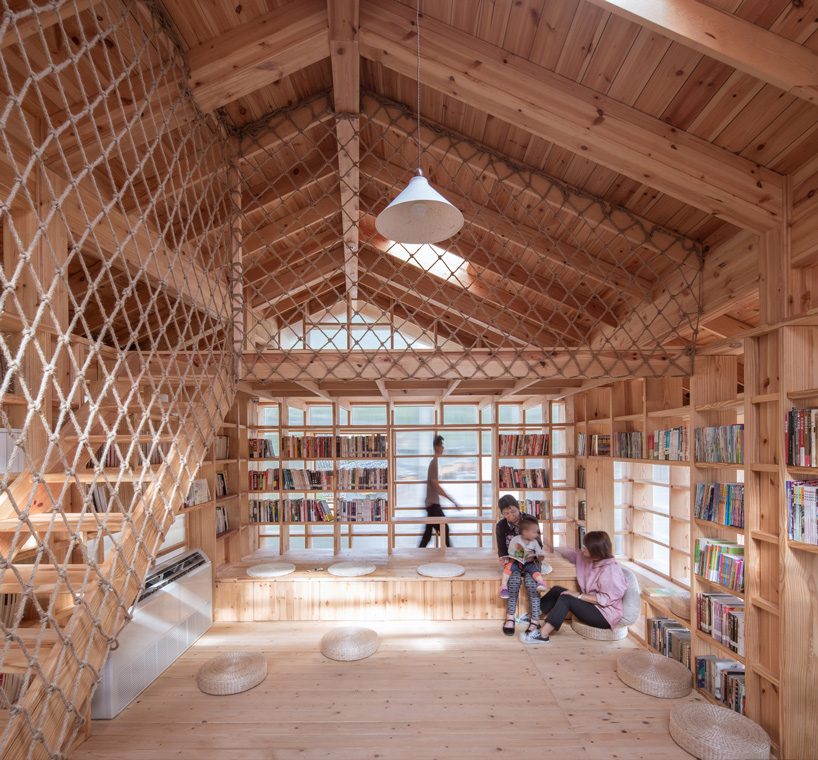 suspended wooden book house is clad in translucent panels by shulin architectural design