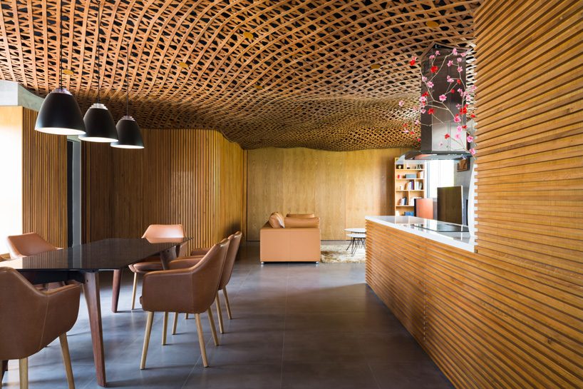 CTA tops vietnam apartment with 'cloud' of interlaced wood on its ceiling