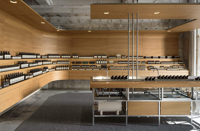 torafu architects uses curved wooden framework to define space of tokyo aesop interior