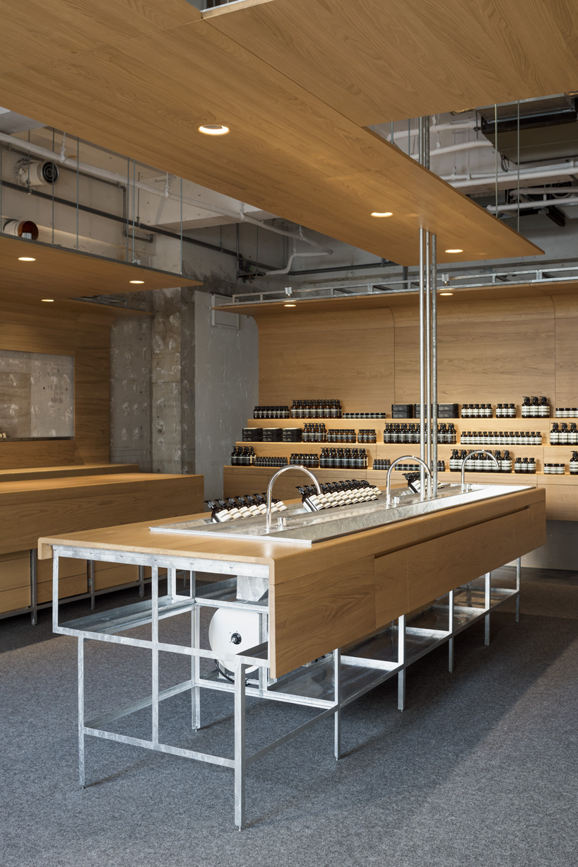 torafu architects uses curved wooden framework to define space of tokyo aesop interior