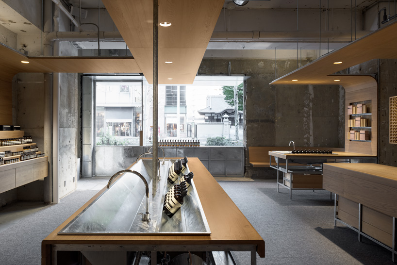 torafu architects uses curved wooden framework to define space of tokyo aesop interior