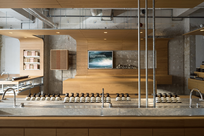 torafu architects uses curved wooden framework to define space of tokyo aesop interior
